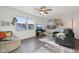 Bright living room featuring hardwood floors, large window, ceiling fan, and gallery wall at 7910 Teel Way, Indianapolis, IN 46256