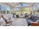 Bright sunroom with many windows, ceiling fan, and comfortable furniture at 7910 Teel Way, Indianapolis, IN 46256