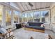 Enclosed sunroom with lots of windows bringing the outside in with neutral decor and ceiling fan at 7910 Teel Way, Indianapolis, IN 46256
