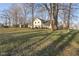 Wide angle exterior shot with large mature trees surrounding home and yard at 7910 Teel Way, Indianapolis, IN 46256