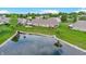 Aerial view of a home with a pond, surrounded by lush greenery and neighboring houses at 7937 Bentley Commons Dr, Indianapolis, IN 46259