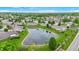 Aerial view of homes surrounding a pond in a quiet community at 7937 Bentley Commons Dr, Indianapolis, IN 46259
