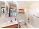 Bathroom features a shower and a wood vanity with countertop and sink at 7937 Bentley Commons Dr, Indianapolis, IN 46259
