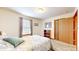 Cozy bedroom with a bed and window and a closet door at 7937 Bentley Commons Dr, Indianapolis, IN 46259