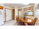 Charming dining area with a wooden table, adjacent to the kitchen and brightened by natural light at 7937 Bentley Commons Dr, Indianapolis, IN 46259