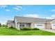 Brick home exterior features manicured lawn and attached garage at 7937 Bentley Commons Dr, Indianapolis, IN 46259