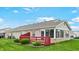 Exterior view with brick facade, red deck, and green lawn at 7937 Bentley Commons Dr, Indianapolis, IN 46259