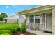 Inviting brick home with cozy front porch seating and manicured landscaping at 7937 Bentley Commons Dr, Indianapolis, IN 46259