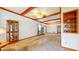 Spacious living room featuring decorative wood beams and view of dining area at 7937 Bentley Commons Dr, Indianapolis, IN 46259