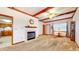 Inviting living room with a decorative fireplace, ceiling fan and a view to the kitchen at 7937 Bentley Commons Dr, Indianapolis, IN 46259