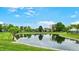 Picturesque community pond surrounded by lush trees at 7937 Bentley Commons Dr, Indianapolis, IN 46259
