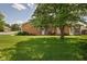 Spacious backyard featuring lush green grass and mature trees providing shade at 8133 Hazen Way, Indianapolis, IN 46216