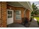 Inviting entryway with brick exterior and cozy seating area by the front door at 8133 Hazen Way, Indianapolis, IN 46216