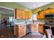 Charming kitchen with wood cabinets and stainless steel appliances that lead to other rooms at 8133 Hazen Way, Indianapolis, IN 46216