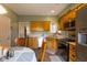 Functional kitchen with stainless appliances and wood cabinetry, open to adjacent rooms at 8133 Hazen Way, Indianapolis, IN 46216