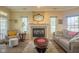 Cozy living room featuring a fireplace, ample natural light, and neutral decor at 8133 Hazen Way, Indianapolis, IN 46216