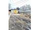 View of the backyard with a shed, fence, and tire tracks at 834 N Temple Ave, Indianapolis, IN 46201