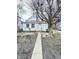 Exterior view of a house with a concrete walkway and large tree in the front yard at 834 N Temple Ave, Indianapolis, IN 46201
