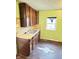 Dated kitchen features wood cabinets, a double sink, and a window at 834 N Temple Ave, Indianapolis, IN 46201