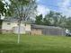 Large backyard with mature trees, utility shed, and fencing at 8417 S Sherman Dr, Indianapolis, IN 46237