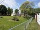 A spacious backyard with a chain-link fence and a storage shed at 8417 S Sherman Dr, Indianapolis, IN 46237