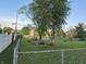 Spacious backyard surrounded by a chain-link fence, trees, and lush greenery at 8417 S Sherman Dr, Indianapolis, IN 46237