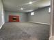 Finished basement featuring a red brick fireplace and neutral carpeting at 8417 S Sherman Dr, Indianapolis, IN 46237