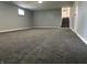 Finished basement with gray carpet, window, and stairs leading up at 8417 S Sherman Dr, Indianapolis, IN 46237
