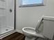 Bathroom with a white toilet and window providing natural light above at 8417 S Sherman Dr, Indianapolis, IN 46237