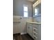 Bathroom with a white vanity, sink, mirror and a window for natural light at 8417 S Sherman Dr, Indianapolis, IN 46237