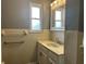 Bathroom vanity with white cabinets and window at 8417 S Sherman Dr, Indianapolis, IN 46237