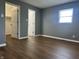 Bedroom with wood-look floors, window, and closet at 8417 S Sherman Dr, Indianapolis, IN 46237