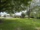 A long shot of a tan brick ranch style home with a green lawn and black shutters at 8417 S Sherman Dr, Indianapolis, IN 46237