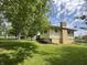 Side view of house exterior with a brick chimney surrounded by mature shade trees at 8417 S Sherman Dr, Indianapolis, IN 46237