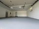 Spacious garage with gray painted floors, offering ample room for vehicles and storage at 8417 S Sherman Dr, Indianapolis, IN 46237