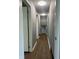 Hallway featuring wood-look flooring and white painted doors at 8417 S Sherman Dr, Indianapolis, IN 46237