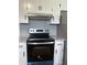 Updated kitchen featuring stainless steel oven and appliances with modern white cabinets and counters at 8417 S Sherman Dr, Indianapolis, IN 46237