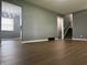 Spacious gray living room with luxury vinyl plank flooring and staircase access at 8417 S Sherman Dr, Indianapolis, IN 46237