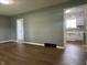 Bright gray living room with luxury vinyl plank flooring and views into the modern white kitchen at 8417 S Sherman Dr, Indianapolis, IN 46237