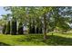 A backyard view shows a deck and evergreens at 8598 Lantern Farms Dr, Fishers, IN 46038