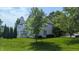 Large backyard with mature tree and manicured lawn of a two story house at 8598 Lantern Farms Dr, Fishers, IN 46038