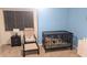 Bright Bedroom with light blue walls, a crib, accent chair, and neutral carpeting at 8598 Lantern Farms Dr, Fishers, IN 46038