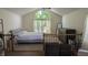Cozy bedroom with a large window, vaulted ceilings, and modern decor at 8598 Lantern Farms Dr, Fishers, IN 46038