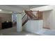Spacious foyer with staircase, piano, and an open view to dining and living areas at 8598 Lantern Farms Dr, Fishers, IN 46038
