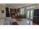 Open-concept living room with hardwood floors, modern furniture, and direct access to the kitchen at 8598 Lantern Farms Dr, Fishers, IN 46038