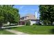 View of the back of the house, with a well-maintained lawn and mature trees at 8598 Lantern Farms Dr, Fishers, IN 46038