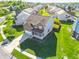 Aerial view of a two-story home with well-maintained lawns and landscaping in a suburban neighborhood at 8644 N Deer Crossing Blvd, McCordsville, IN 46055