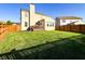 Spacious backyard with a lush lawn, wooden fence, and a view of the home's rear exterior at 8644 N Deer Crossing Blvd, McCordsville, IN 46055