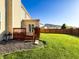 Backyard with a well-maintained lawn, wood fence, deck, and sliding glass door entrance to the home at 8644 N Deer Crossing Blvd, McCordsville, IN 46055