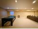 Basement featuring a pool table, neutral walls and carpet, a window, and a large sofa at 8644 N Deer Crossing Blvd, McCordsville, IN 46055